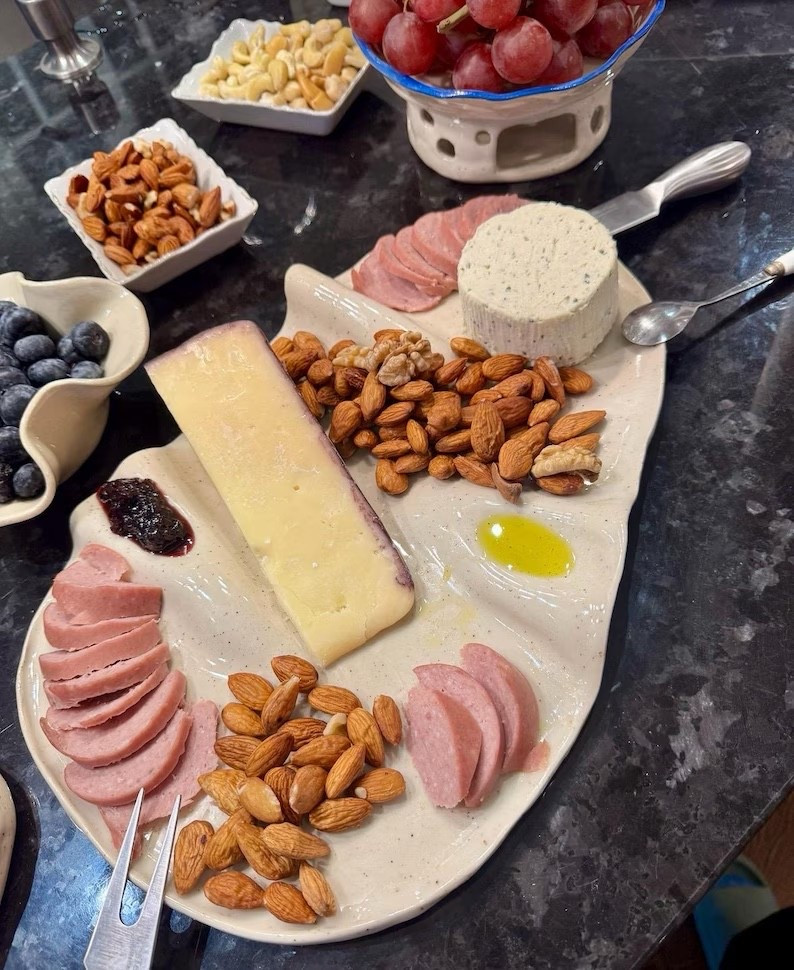 Elevated entertaining made easy 🤍 This neutral ceramic serving platter is my go-to for effortless charcuterie boards, appetizer spreads, and hosting nights at home. The organic shape + subtle speckled finish instantly makes everything look styled—no effort required.

Perfect for:
• Charcuterie boards (cheese, meats, nuts, fruit)  
• Appetizer trays for parties  
• Holiday hosting + gatherings  
• Everyday kitchen styling  

I love how the built-in sections naturally guide the layout—cheese, cured meats, olives, nuts, and a drizzle of olive oil all have their place. It’s functional, minimal, and looks high-end on any countertop.

If you host at all, this is one of those pieces you’ll reach for constantly.

#LTKHome #LTKHosting #CharcuterieBoard #Serveware #HostingEssentials #KitchenStyle #EntertainingAtHome #CheeseBoard #NeutralHome #ModernFarmhouse #KitchenInspo #HomeDecorFinds #LTKUnder50 #LTKStyle

#LTKHome #LTKMothersDay #LTKselfcare