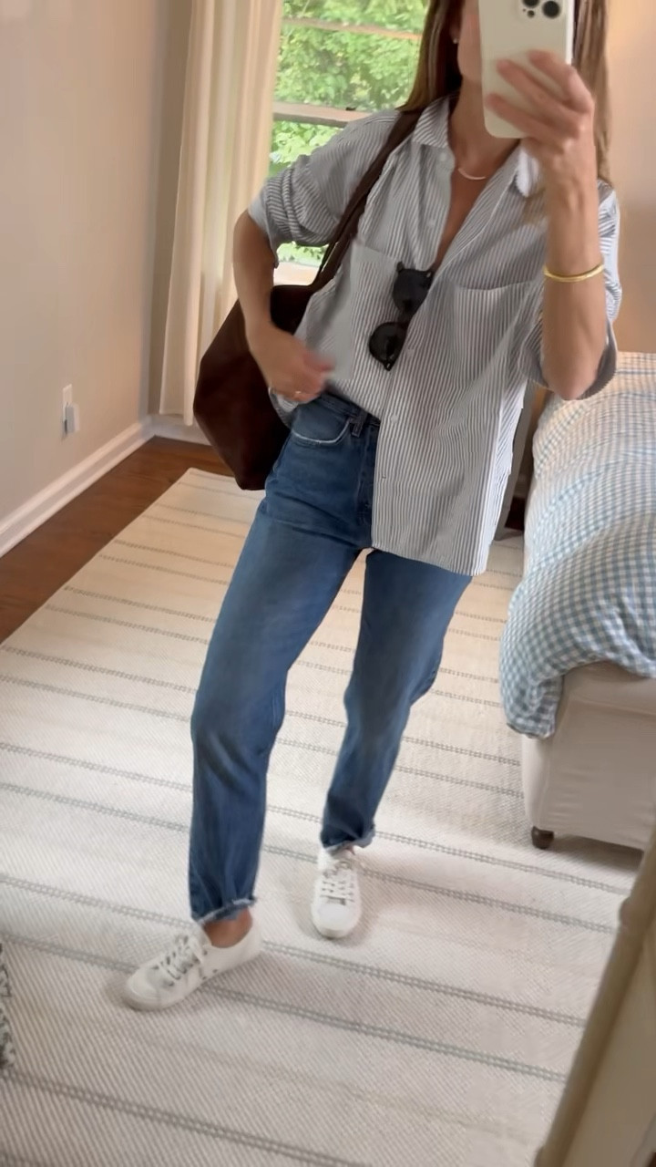 Ok guys had some fun talking in front of the camera for a change! Tried to give some more detail on style tips for wearing an oversized button down and how to accessorize closet staples to pull something together that is chic and looks effortless! Best jeans, best button-down, beautiful new bag, fun jewelry to complete the look. This is my style to a T. 

Full post details below ❤️

Happy Wednesday! All closet staples today ☕️🍂✨ 💫 AGOLDE 90’s Pinch Waist Straight Leg jeans. The beauty of these jeans is they look like a vintage pair but fit so well — high rise, straight leg, and this dark wash feels perfect for fall/winter and wear them with tee shirts sweaters or button downs like I did today! Runs TTS. I am 5’6’m and wearing a 25• EVERLANE Boxy Oxford is one of the top 10 pieces I’d get if I were rebuilding my wardrobe today and it’s less than $100! No surprise it gets 4.7 stars! This is truly the button-down I reach for most — crisp but relaxed, polished but still easy). I especially love this black and white stripe option but there are so many great colors. Check out the sleeve roll and tuck. You all ask about this a lot! Wearing a small (my true size) • SEAVEES sneakers are super comfortable and go with everything. 4.9 stars! • Wearing my usual sunnies + earrings. Mixing it up with a beautiful Dorsey necklace which is so important with a button down where some neck and chest are visible. Simple, casual, effortless 🤍

#LTKFindsUnder100 #LTKFindsUnder50 #LTKSeasonal