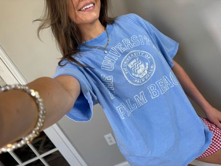 Gorgeous light blue graphic Tee! 
“The university of palm beach” 
Natural oversized fit, wearing a size small 

#LTKstyletip #LTKSeasonal #LTKfindsunder50