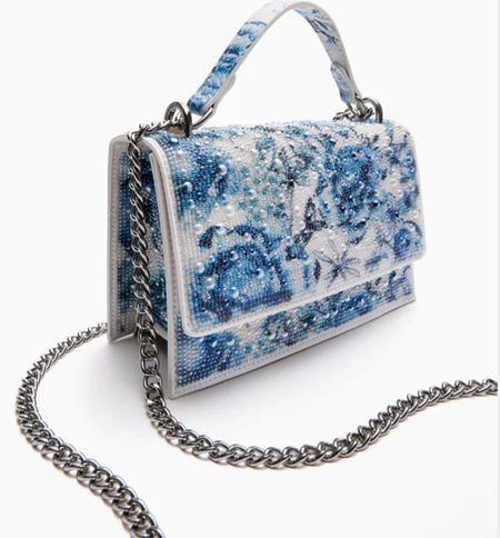 Betsey Johnson Pearl Toile Convertible bag blue/ multi. Soar into style with the stunning floral rhinestone flap bag. The enchanting flower design is accented with classic pearl stones, giving this bag a touch of glamour. This multi-functional accessory can be used as a traditional clutch for a night out, or as a crossbody bag for a hands-free option.

#LTKitbag #LTKstyletip #LTKSeasonal