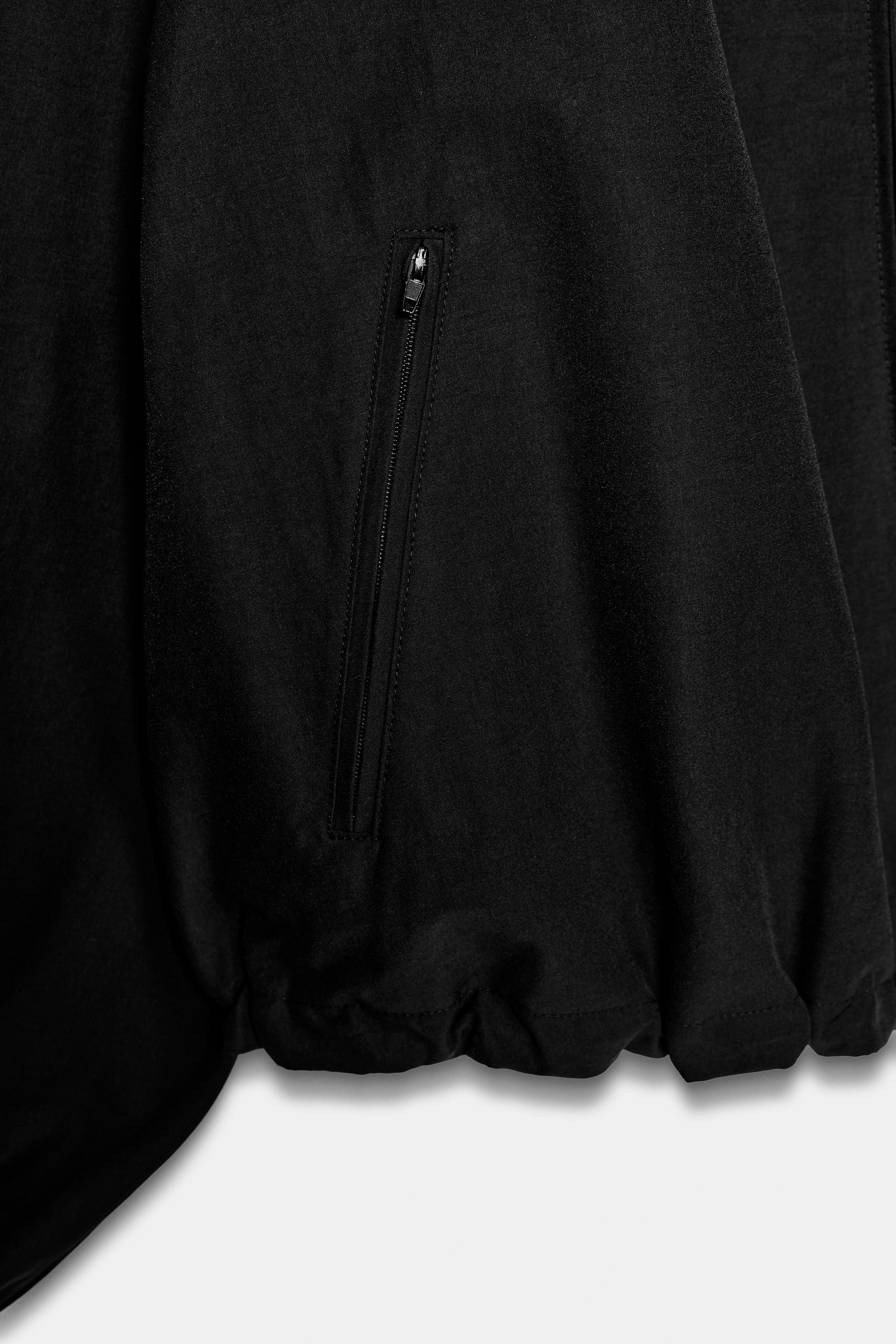 High-neck, long-sleeve jacket with shoulder pads. Features front zip pockets. Hem finished with a... | Zara US