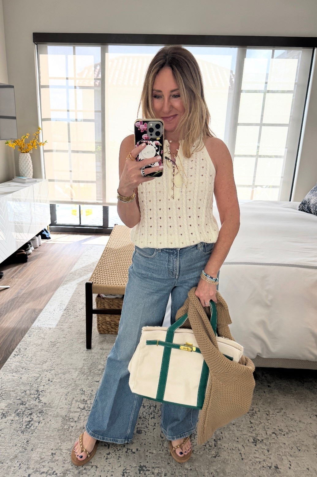 We had dinner out with friends and it was a warm evening. The sleeveless sweater is so cute and works nicely with a plain nude racer back or strapless bra. And I really love how these Spanx jeans fit. Each pair hits just at the right part of the waist with a nice wide waistband. I take a small petite and they hit perfectly in length. This bag isn’t gameday luxe- not linkable for you! 

#LTKgrwm #LTKdayinmylife #LTKootd