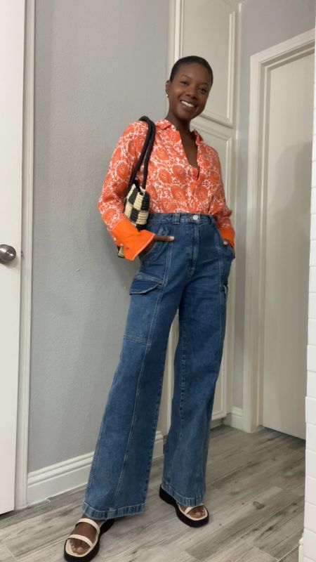 Spring outfit! Orange paisley print button up top, wide leg cargo denim jeans, white double strap platform sandals, gold huggie earrings and black and white gingham tote purse  

#LTKworkwear #LTKunder100 #LTKtravel
