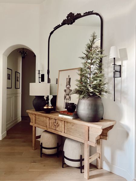 Our Christmas entryway decor.

Ottomans, Lamp , books and small vessel are in my Found home and design collection ( linked in my IG bio )



#LTKhome #LTKSeasonal #LTKHoliday