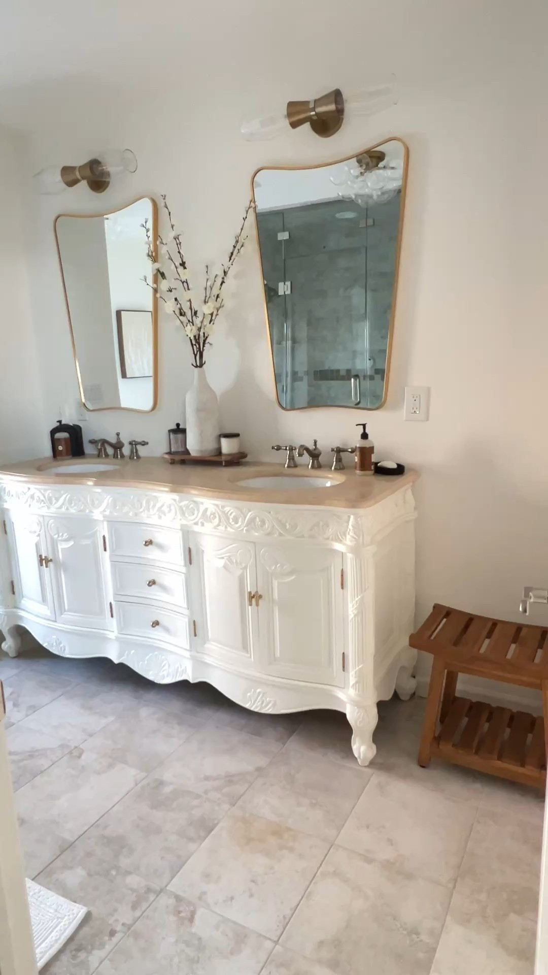 Bathroom remodel decor ideas that will make your master bath look expensive on a budget. Complete with a vintage vanity, gold organic mirrors, new knobs and pulls, teak shower bench, towel rack and bar, freestanding toilet paper holder and bathroom decorating ideas  
Yt community post 12/11/25

#LTKSaleAlert #LTKOver40 #LTKHome