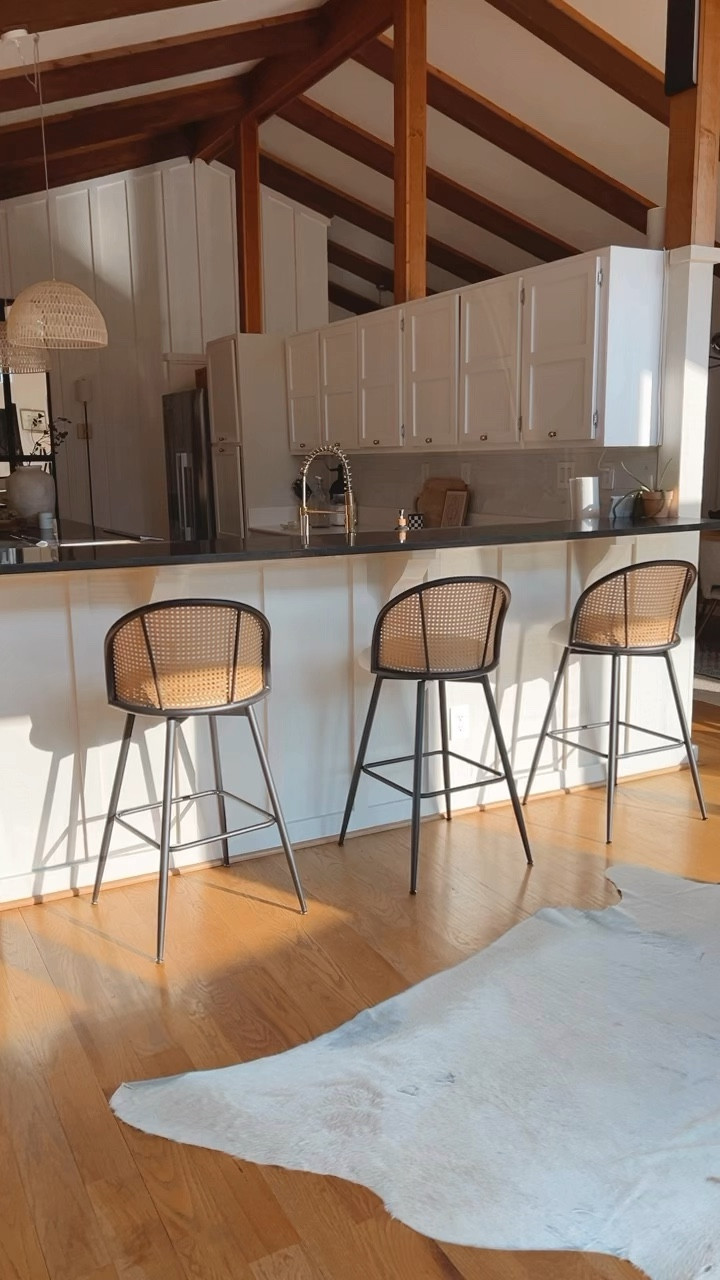 These fabulous cane bar stools are not only so comfy and kid friendly, they add so much texture and depth to my kitchen. I love how they swivel so you can see the waterfront views from my sliding glass doors. Can you believe these were from Amazon?!  They were a freakin’ steal! I got the off-white faux leather in a set of 3!  #barstools #stools #cane #modernkitchen #kitchen #decor #amazon #amazonfinds #canefurniture #budget #furniture #kitchendecor #bohodecor #moderndecor #midcenturymodern 

#LTKSaleAlert #LTKHome
