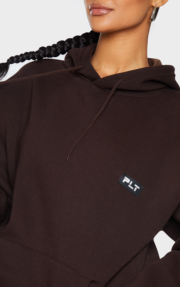 PRETTYLITTLETHING Chocolate Logo Badge Detailed Oversized Hoodie | PrettyLittleThing US