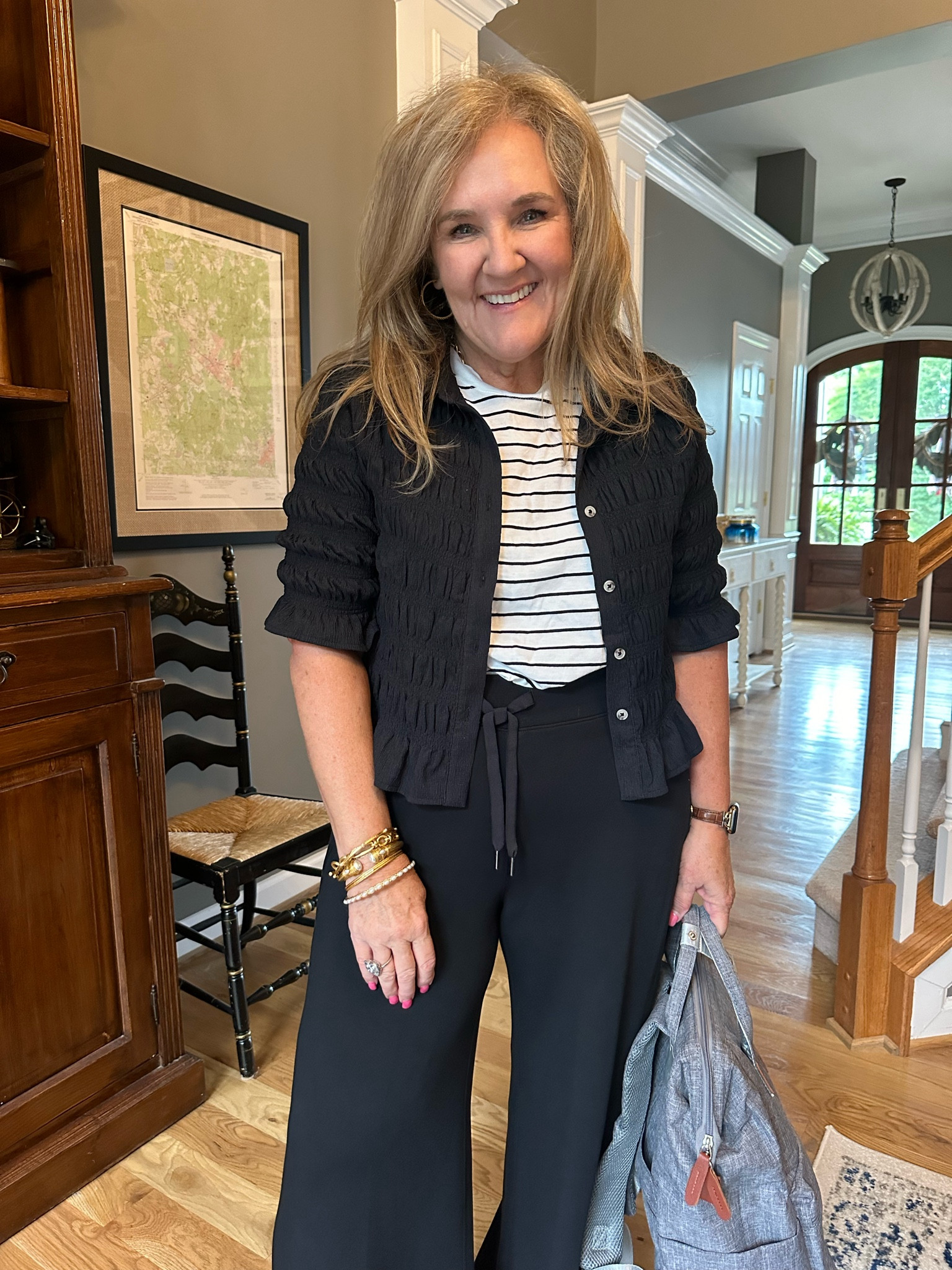 Elevated travel outfit. 

My spanks air essentials pants never fail. Yes they feel like sweats, but they look like an elegant pant. They drape beautifully and people know the difference. I wear a size XL petite 10% off code and free shipping.  NANETTEXSPANX 

Size large in the target Tea and size large in the Anthro smocked top. The top is so versatile it’s stretchy. It’s comfy. It’s lightweight. It gives the look of a jacket or cardigan or can be worn buttoned up as a top. 

My backpack comes in two sizes. This is the smaller size. It holds two laptops, your cosmetics and outfit upon arrival and even your purse if you need to stash it in there for boarding. 

Anthropologie target spanx Travel outfit