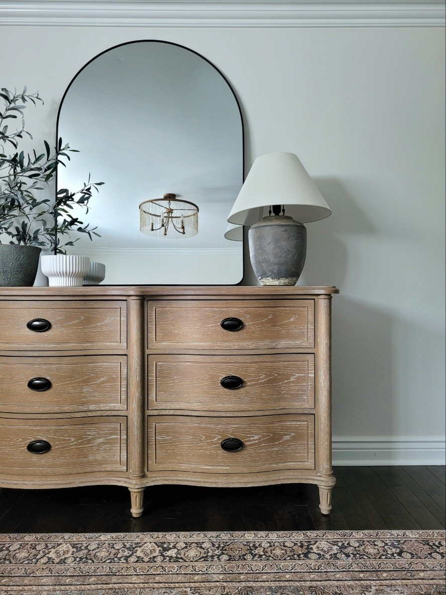 Primary bedroom dresser decor with an oversized arch mirror, table lamp,  and neutral vintage inspired rug. This dresser is such a great designer look for less! Bedroom decor, primary bedroom,  neutral rug

#LTKHome #LTKSaleAlert