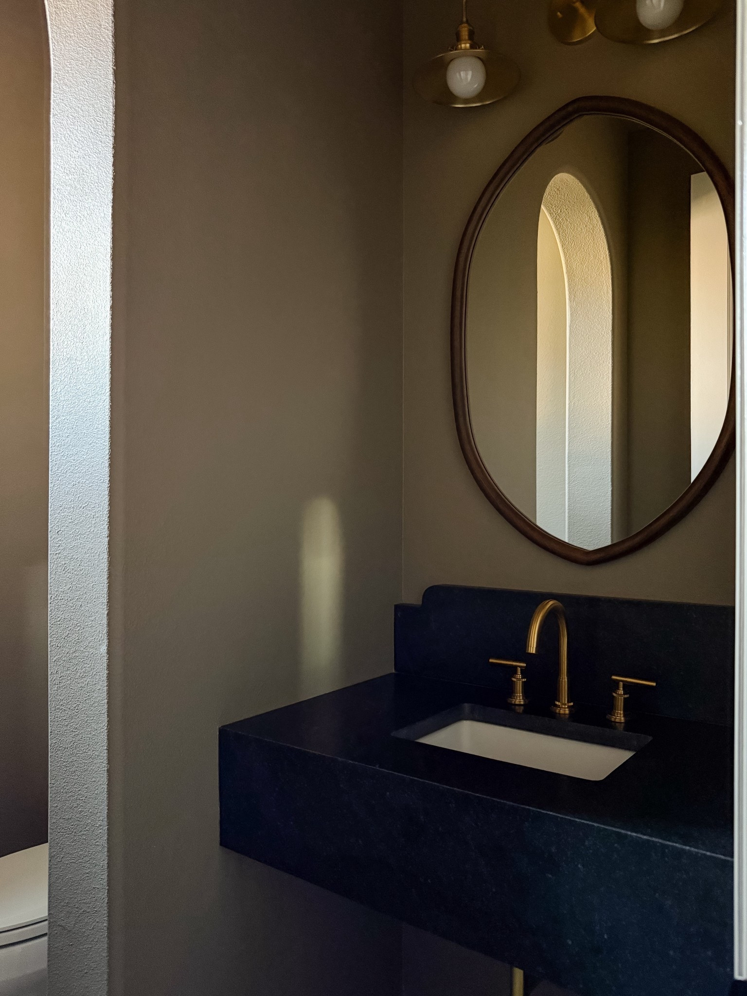 Powder bathroom makeover progress with floating soapstone sink, wood mirror, brass bathroom faucet, and brass vanity light fixture 🖤✨



#LTKHome