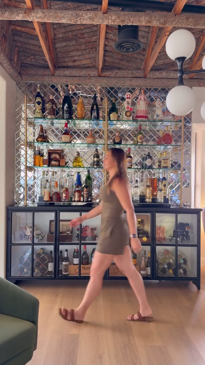 Bar tribute to my best friend and the best bar owner of 1971, my dad.

I wanted to give the antique bottles my dad saved from his original bar in the 60’s a proper home, so I made this eclectic bar.

The mirror tiles and gold pipe shelves say party on top and tuxedo on the bottom. I had half inch glass shelves made to support all of the items on display. 

This project challenged my skills in a couple areas; first the spray paint wasn’t adhering well to the pipe and then the mirror tiles are so sticky that it made placement on the wall very difficult to maneuver because of the small mirrors inset within the mosaic that are very fragile.

All in all, I am happy with the look and can think of a ton of ways to replicate this process just by using different tiles, wood shelves, or another sideboard.