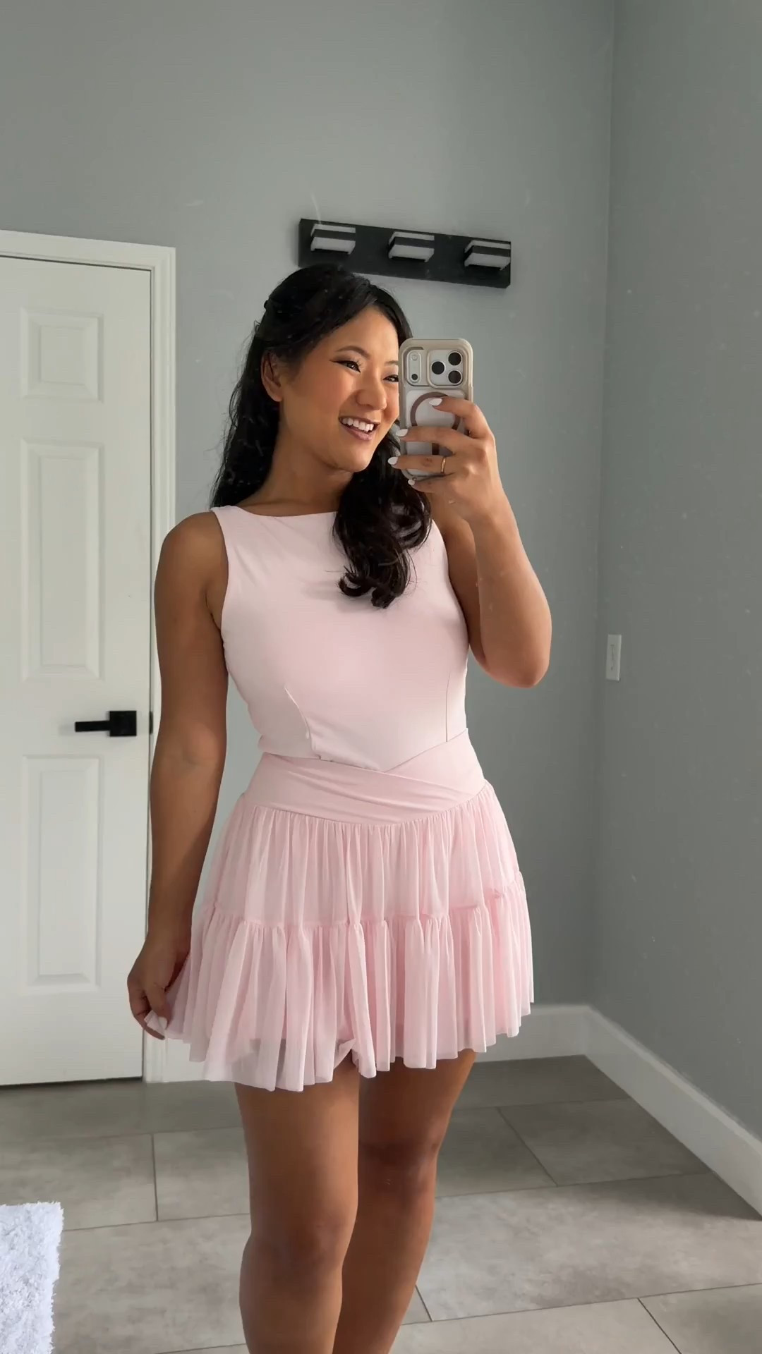 Blogilates Women's Ballerina Skort wearing size medium. Blogilates Women's Boatneck Crisscross Tank Top wearing size large. Blogilates Women's Marshmallow Full Zip Hooded Sweatshirt wearing size medium. 