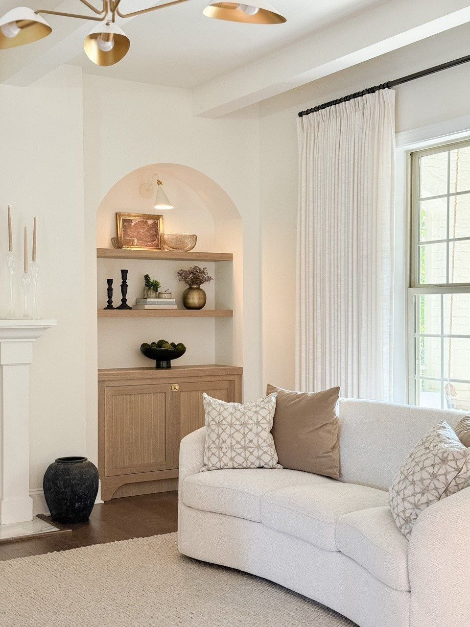 Living Room. Upholstered Sofa, Moss Bolls, Liz Linan Drape Pleated, Ceiling Light, Brass Wire Decorative Bowl, 1 Light Wall Sconce, Cogan Armed Sconce, Area Rug, Moody Trees Framed Wall Canvas Board. 

#LTKHome