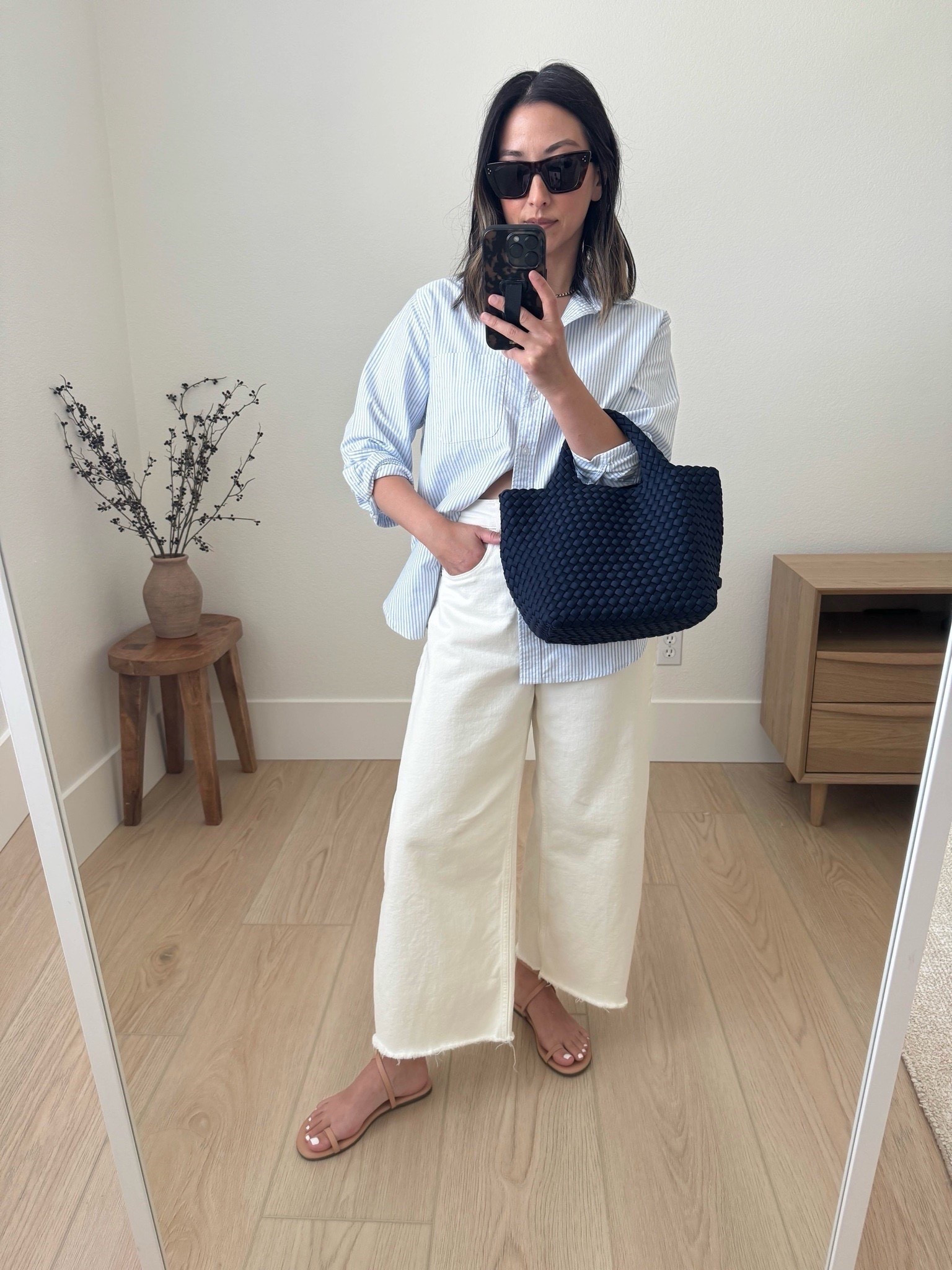 My favorite Everlane curve jeans. Exaggerated for sure but they’re so good! I sized up 2 sizes for comfort. Very high rise. Cut the hems. 

Everlane shirt 4
Everlane jeans 26. Cut hems 
Tkees sandals 5
Naghedi mini navy 
Celine sunglasses 

Petite style, jeans, summer style 

