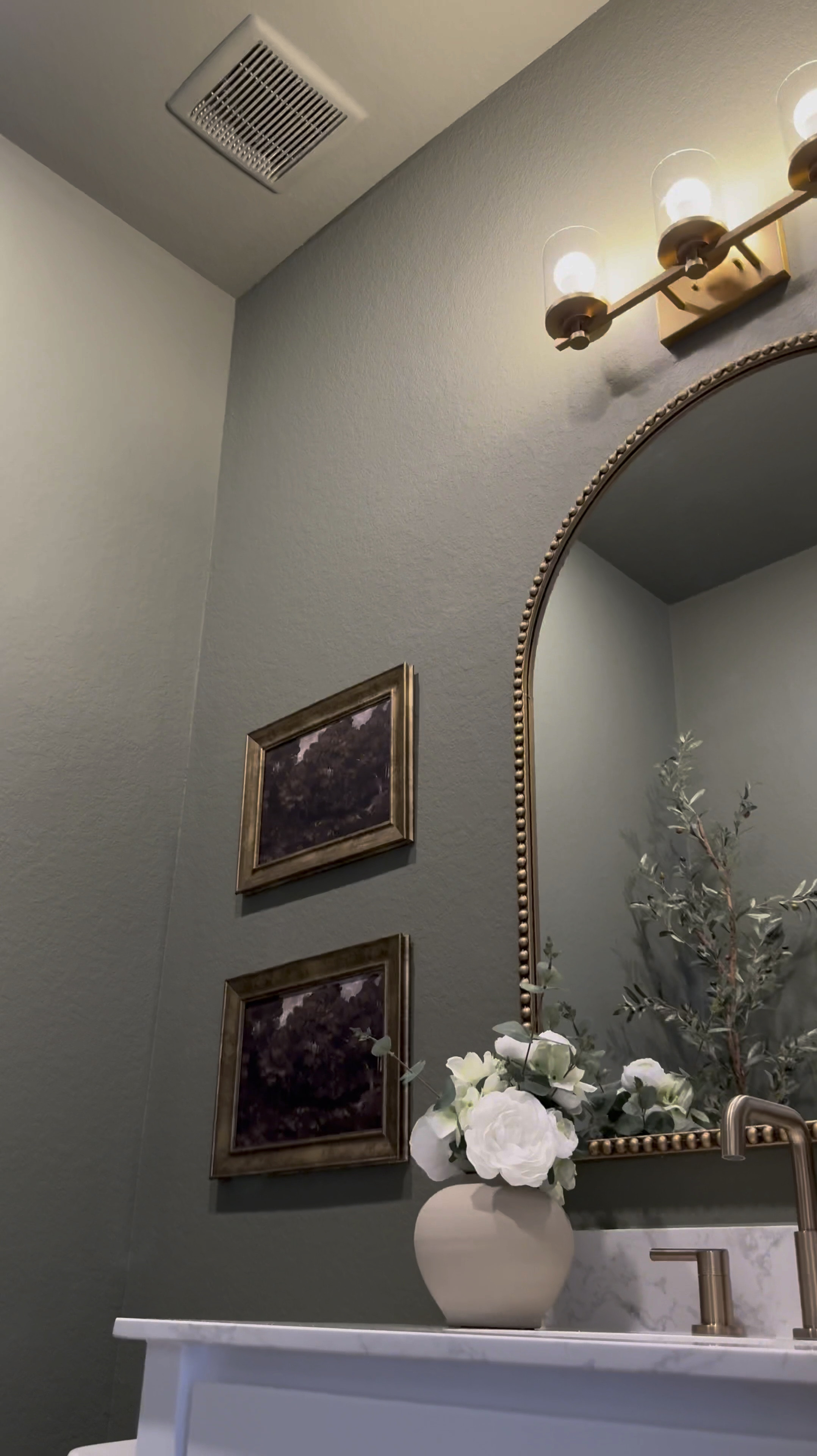 Comment: Bathroom

If you’re considering painting your powder room green, I’m telling you, THIS might be the perfect color for you … go for it! 

I used flat finish for the walls and painted the baseboards in satin finish… 

I’ll be honest, I was apprehensive at first … I even paintings the ceiling 😬 believe it our not, it made the room feel larger! 

I chose brass finishes bc I really wanted the space to have a vintage feel… well, modern vintage…??? If that’s a thing 😆.. 

The mirror is 30x40 inches… 

I added a new light fixture and it now faces upwards … which made that wall feel taller 

I wasn’t in love with this builder grade vanity tbh😆, matter-fact, I wanted to change it… it wasn’t functional …but now i wanna keep it lol 😂… I added brass hardware, these cute baskets from Walmart, led light strips on the bottom and now it’s a whole new unit….. you can even add battery powered/rechargeable/plug in led light strips .. whatever fits your lifestyle 

Ok let’s talk about this stunning planter!!! …. You know I love me an olive tree 😆… and I wanted something tell and slim… this planter was the perfect for plus it added to the moodiness 🥰

I am in love with this space… I wanted to create a vintage-cottagy feel in this powder room, while the rest of the home feels modern. 

#LTKStyleTip #LTKHome #LTKVideo