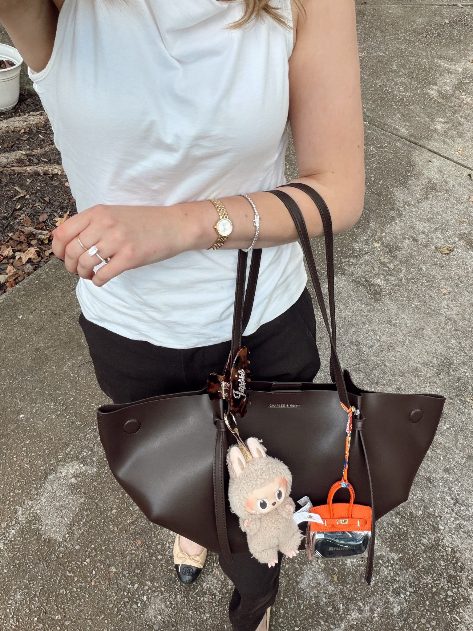 OOTD
Charles & Keith Calla tote bag best everyday work bag
Uniqlo smart trousers
Boat neck tank 
Labubu bag charm
Transparent purse key holder bag charm


#LTKWorkwear #LTKItBag