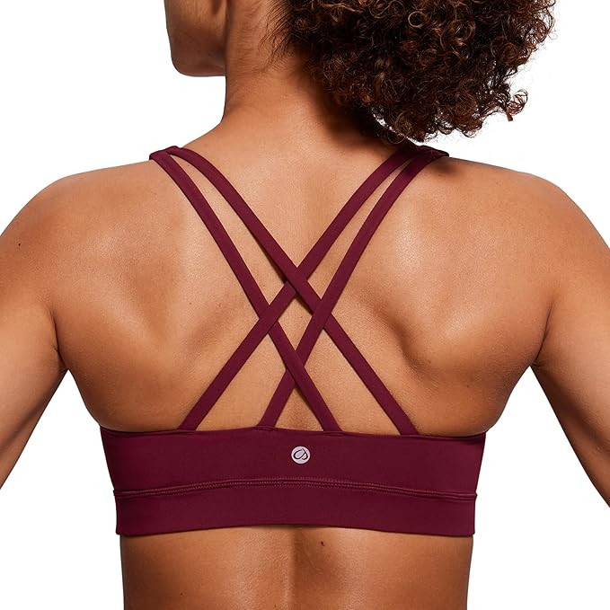 CRZ YOGA Women's Strappy Sports Bras Fitness Workout Padded Yoga Top Criss Cross Back Cami | Amazon (US)