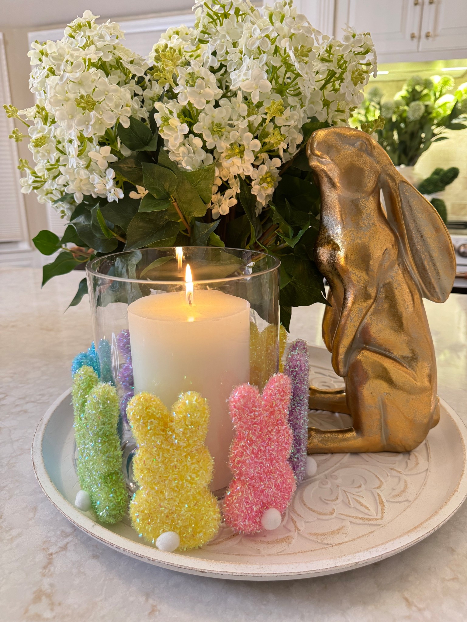 Spring is in the air, and Easter magic is on display! I made this cozy candle centerpiece, wrapped in pastel bunnies and paired with a golden bunny statue to bring warmth and whimsy to our table. The fresh white blooms add the perfect touch of charm.  🐰 🕯️ 💛🩵🩷

#EasterDecor #SpringCenterpiece #BunnyVibes #TableDecor #EasterCandle
#PastelDecor #EasterVibes 

#LTKHome #LTKSeasonal