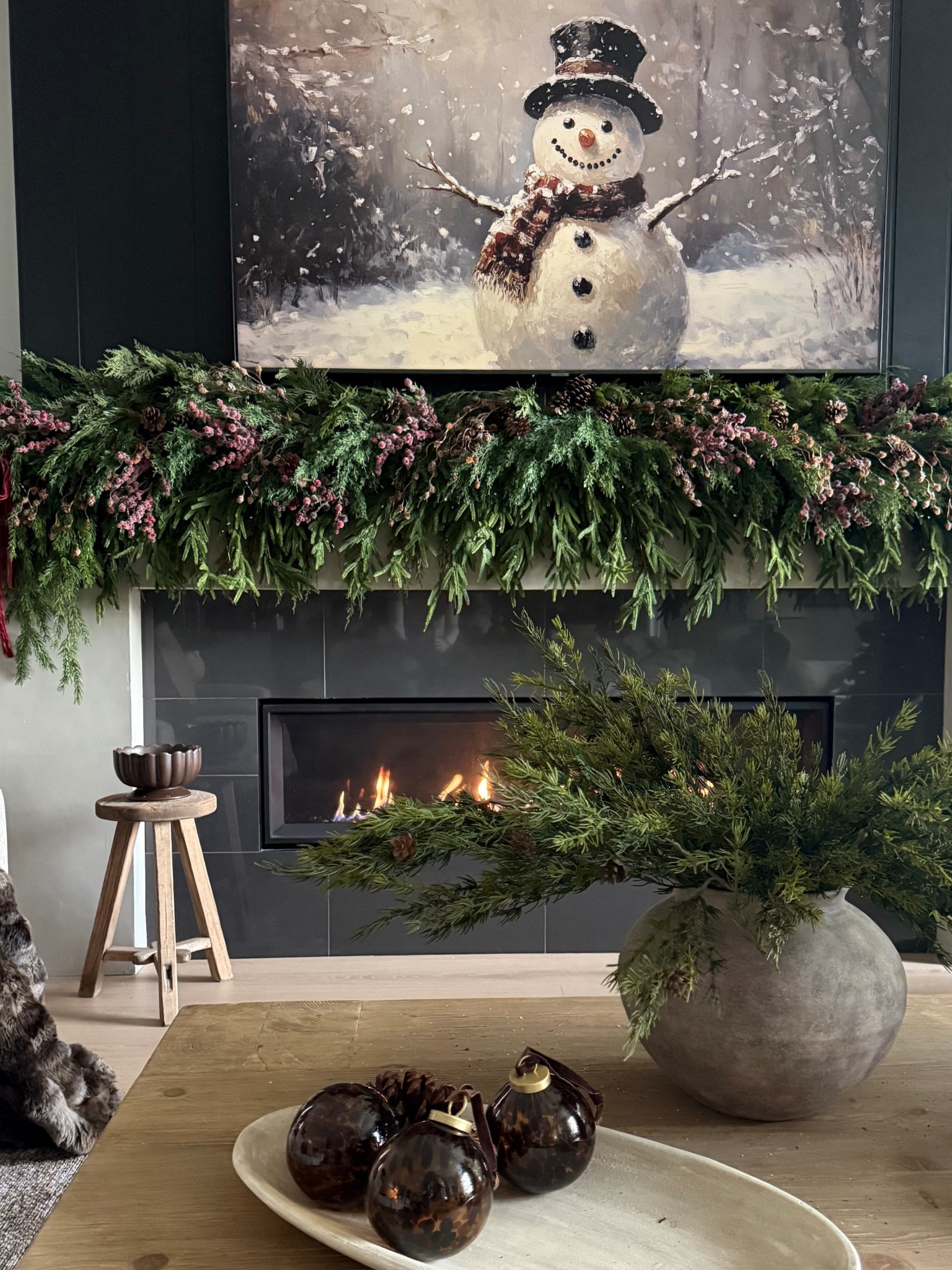 Winter nights in.. love this cozy view🤎
Mantel details: one layer of the Norfolk pine, one layer of cypress. Several draping pine stems tucked throughout. 
Pinecones and berry picks throughout! 