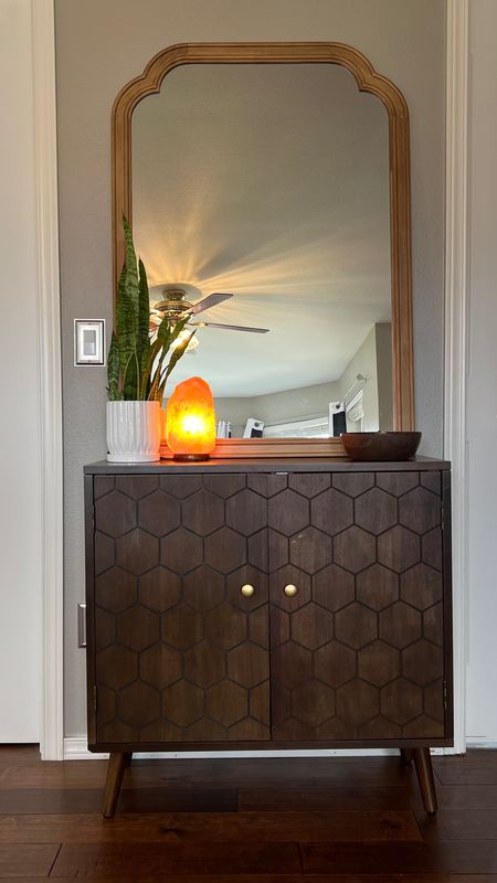 Honeycomb cabinet, decorated with a mirror, snake plant, salt lamp, and a bowl of crystals. It matches the nightstands in my bedroom perfectly. 

#LTKstyletip #LTKsalealert #LTKhome