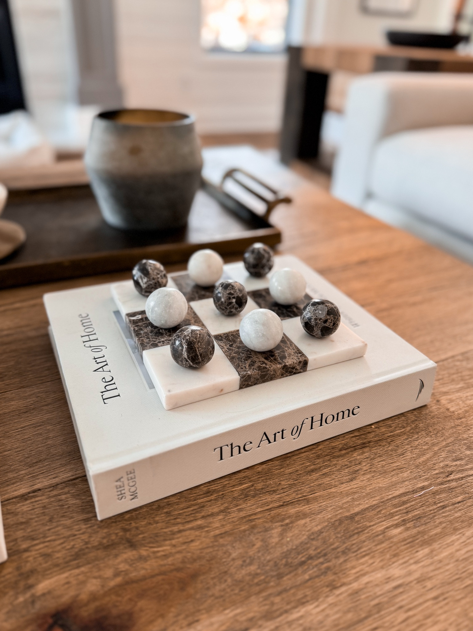 My favorite piece of coffee table decor is our beautiful marble tic-tac-toe board. It’s definitely a splurge but not only does it make a beautiful statement, but we also play tic-tac-toe all the time! 

#LTKStyleTip #LTKHome