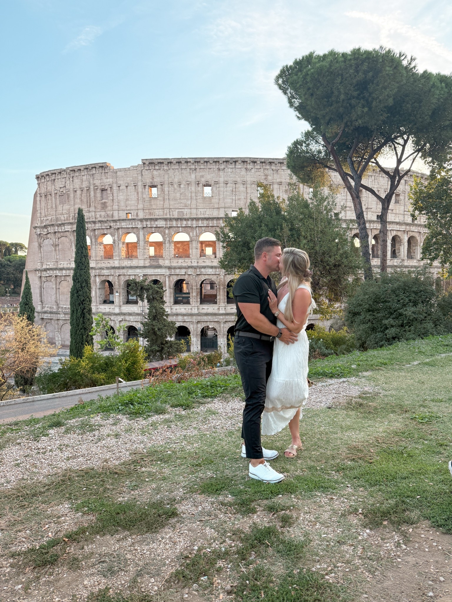 This is your sign to catch the sunset in Rome during your honeymoon! 
We kept it classic for our date night by the Colosseum — a white midi dress for me, a black button-down for Richie — simple pieces that always photograph beautifully against the city’s golden glow.

If you’re planning an Italy honeymoon, outfits that feel effortless and elevated are the way to go. Think neutrals, clean lines, &amp; timeless silhouettes you’ll love in every photo 10 years from now.

Save this for your Rome honeymoon style planning &amp; follow @kitchensinkit for more Europe travel outfits.

Rome honeymoon outfits, Italy honeymoon fashion, Europe honeymoon outfits, white dress Italy honeymoon, black button-down men’s outfit Italy, couples honeymoon outfits Europe, Colosseum date night outfits, chic Europe travel style, honeymoon fashion inspiration Italy, black &amp; white couples style, romantic date night outfits Rome, luxury honeymoon outfit ideas Europe, timeless honeymoon fashion, elegant honeymoon outfits Italy, Rome couples style outfits

 

 #LTKTravel #LTKMens #LTKWedding