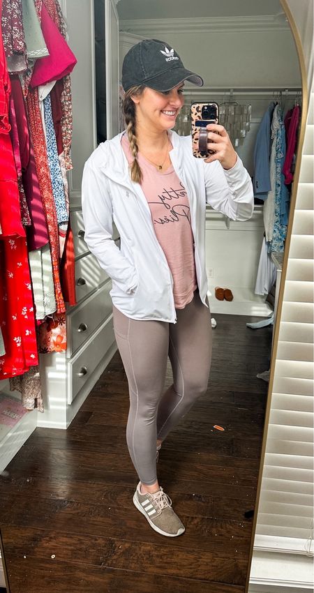 Workout outfit of the day! Love this lightweight running jacket I found on Amazon! Has a hood, thumb holes & full zip! comes in tons of colors. Perfect to tie around the waist with leggings or wear over casual clothes! Paired it with my pretty plies barre tank top and high waisted “stay put” postpartum leggings!! (Love these!!) 

Adidas hat, adidas running shoes, casual mom outfit, errands outfit, yoga pants, Fitness finds, workout clothes, lounge, athleisure, barre workout, running outfit, casual outfit, travel look

#LTKfitness #LTKSeasonal #LTKtravel