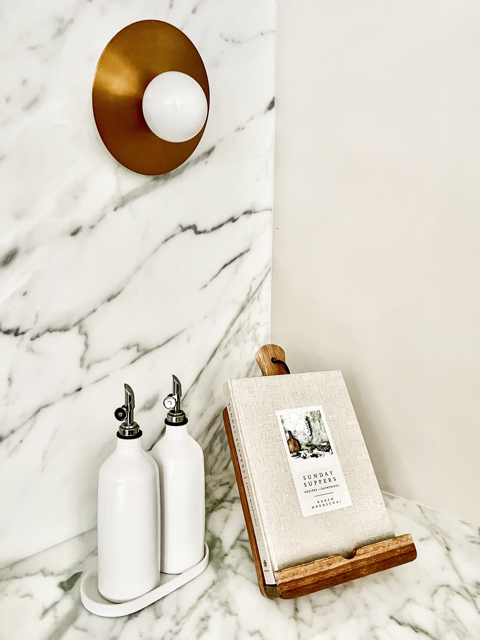 Shop my kitchen cookbook and Acadia stand! Both from Amazon
Olive oil dispenser, marble kitchen, round sconce, Acadia cookbook stand, cookbook, Sunday Suppers

#LTKhome #LTKsalealert #LTKfamily