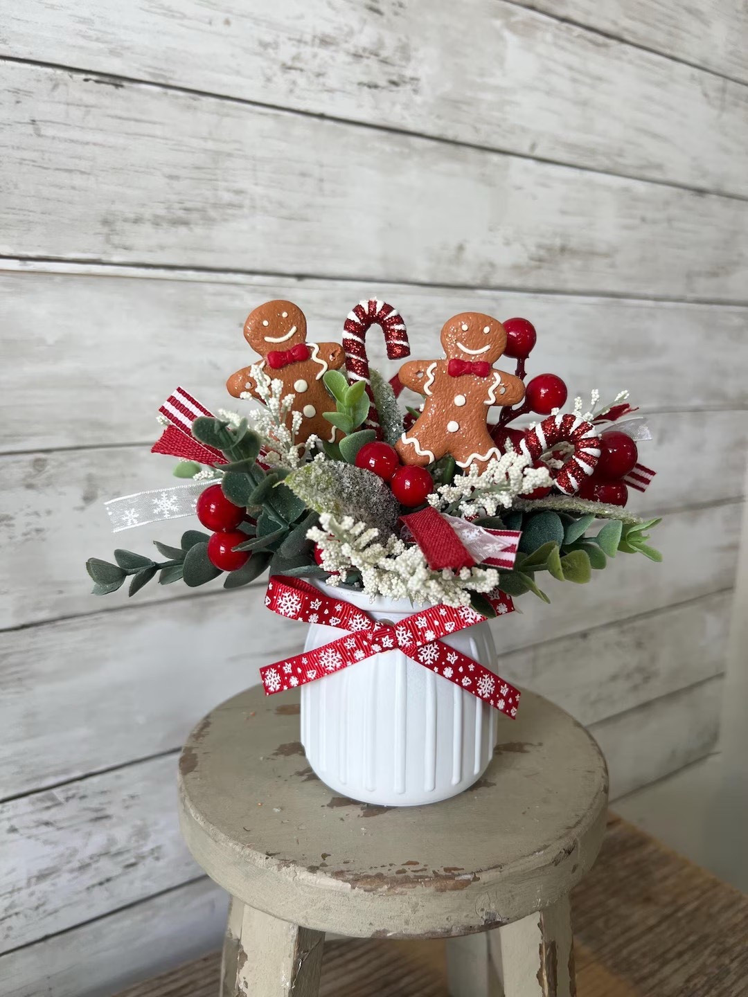 Bring a little holiday magic to your space with this charming gingerbread-themed mini arrangement from PinkLizzyDesigns! Each hand-painted jar comes filled with festive faux greenery, sparkly mistletoe, white florals, red berries, candy canes, and the sweetest gingerbread accents. At about 8” tall when arranged, it’s the perfect size for shelves, trays, desks, or anywhere that needs a touch of whimsy. Plus, it ships right from New Jersey for quicker, eco-friendlier delivery. #EtsyFinds #HolidayDecor #GingerbreadDecor #ChristmasVibes #HomeStyling #LTKHoliday #LTKHome #PinkLizzyDesigns

#LTKSeasonal #LTKHome #LTKHoliday