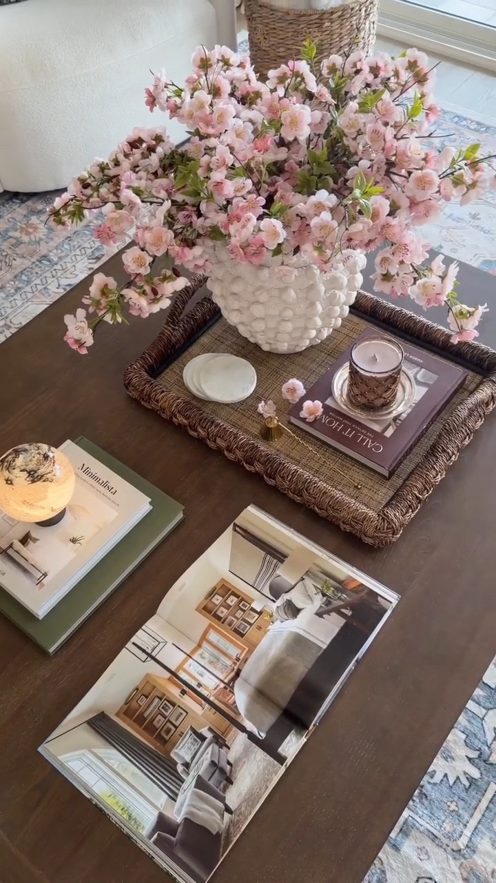 Spring styling, but make it effortless 🌸

Faux florals for that forever-bloom, a simple tray to keep it all grounded, soft candlelight for cozy evenings, a few favorite books, and a warm glow from the lamp… this is your sign to refresh your coffee table for spring ✨
Little layers, big difference.

#homedecorideas #coffeetabledecor #coffeetablestyling #livingroomdecor #coffeetable

#LTKHome #LTKSaleAlert