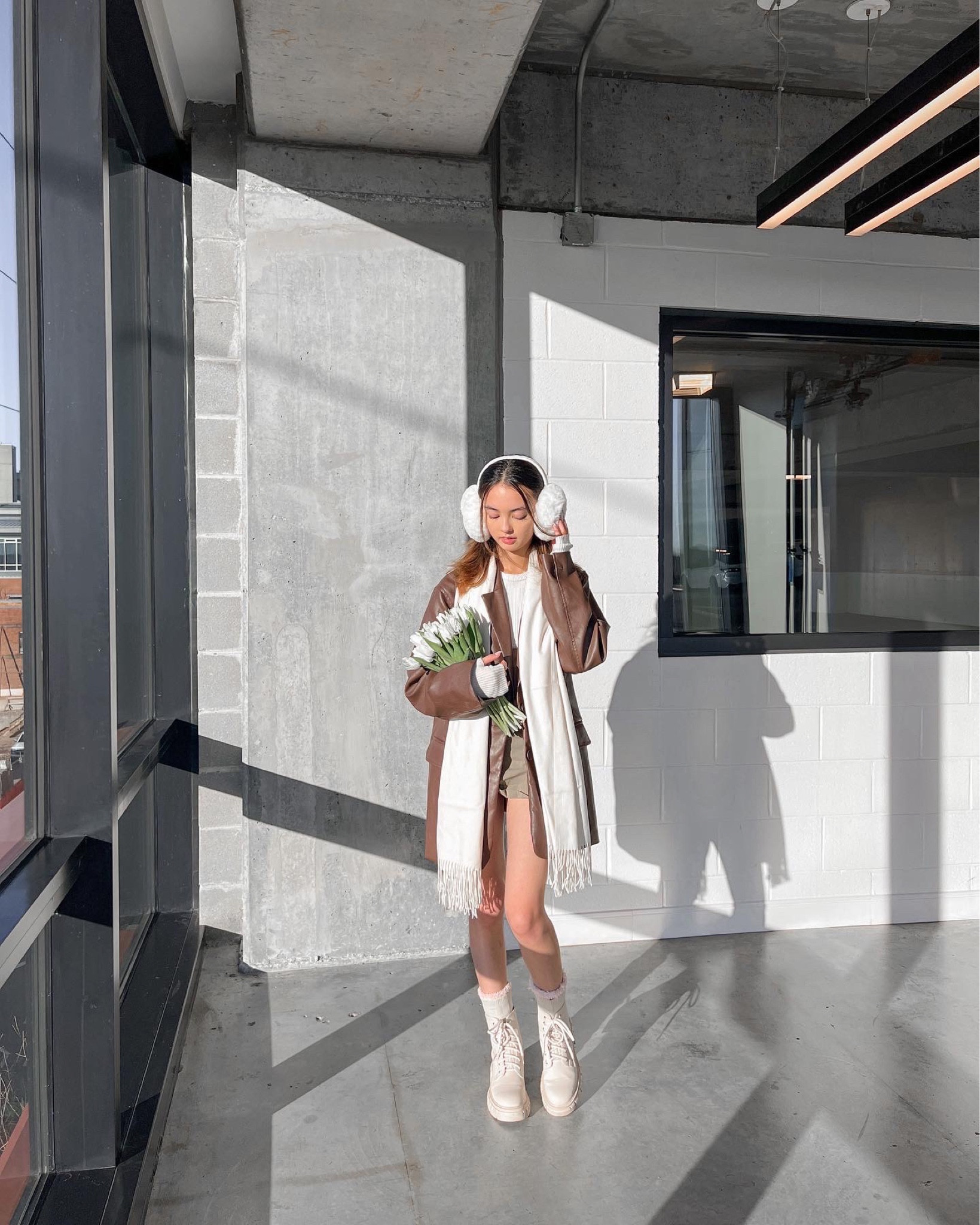 spring outfit winter outfit neutral outfit brown faux leather blazer brown blazer mini cargo skirt white scarf white earmuffs white tulips cream hiking boots white arm warmers 