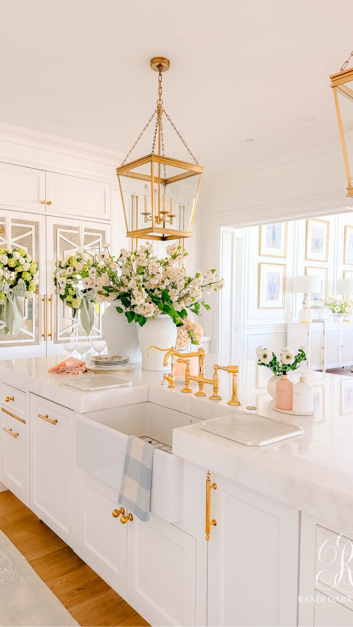 Everything I used to style our kitchen for spring! 
How many stems I used…

5 white ranunculus in the small pearl vases

8 of the peach ranunculus in each arrangement flanking the stove

8 peach cherry blossoms in the white ginger jar and 2 green leaf stems 

8 ranunculus in the white ginger jar

2 sets of the peachy pink hydrangea 
1 set of the green florals
1 set of the peach florals 
in the French planter 

#LTKSeasonal #LTKHome