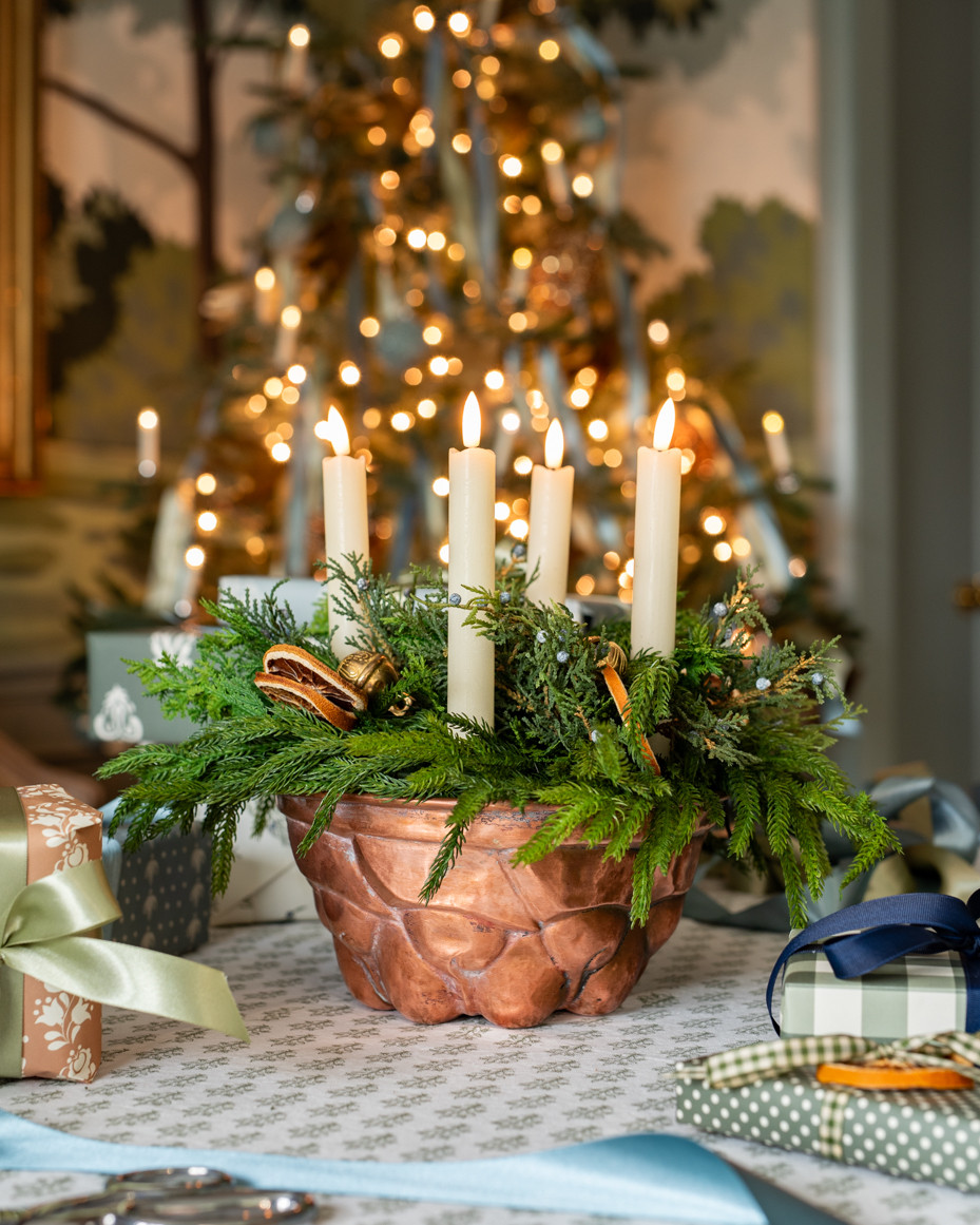 A holiday centerpiece using an antique copper bundt pan (made with faux greens and real wax LED candles)... 

 #LTKHoliday #LTKHome