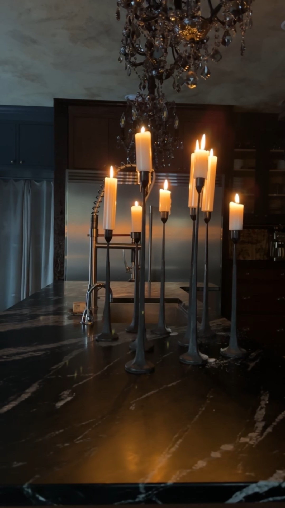 Tall candlesticks set in dark candle holders, grounding a moody wooden kitchen in warmth and drama. Paired with black chandeliers, the glow feels intimate, old-world, and effortlessly atmospheric. Shop now on LTK 🖤🕯️

#CallSignDesign #Vintage #Luxury #InteriorDesign #InteriorDecorating #Elegance #Chandelier #OldWorldCharm #DesignStyle #CastleCore #OldWorldCharm  #SimpleSwaps