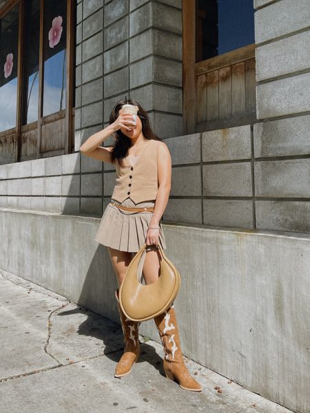 Spring Outfit idea with this unique shaped purse from @meliebianco 🤗 style with a tan vest and mini skort. Finish with a pair of cowboy boots for a touch of festival vibes for spring and summer festivities 🤎💯

#ad #festivallook #brownpurse #springoutfit #summeroutfit #allneutraloutfit #tanoutfit 

#LTKstyletip #LTKtravel #LTKSpringSale