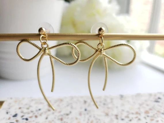Gold bow earrings, big ribbon bow tie dropping earrings | Etsy (US)