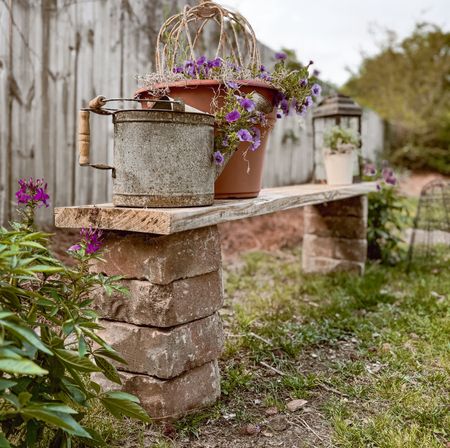 Cozy little cottage garden bench DIY using brick pavers & a piece of wood. Our wood was a scrap piece we had laying around but I’ve linked the same we used for this bench— just cut it to the length we wanted. Pavers cost around $25 (we used 8 of them— 4 on each side) & then add in the wood, this project is around $40. 🙌🏼🪴🍃

#LTKSeasonal #LTKfindsunder100 #LTKhome