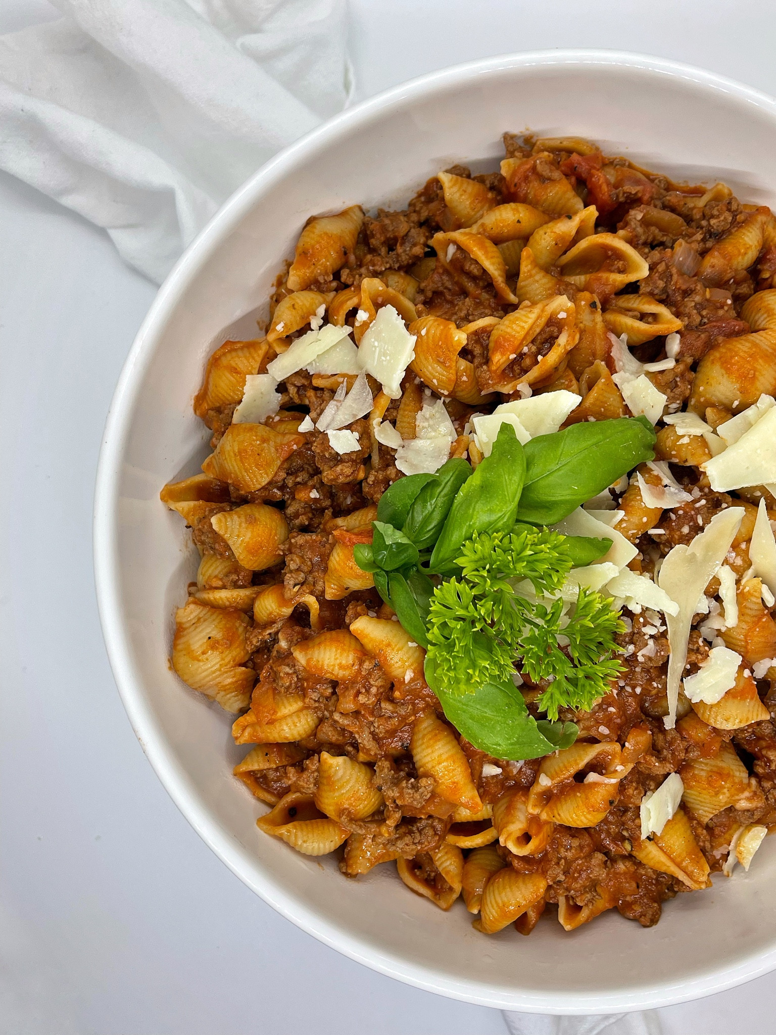 Here’s a 25-minute meal perfect for busy weeknights, meal prep or Sunday dinner. 🤌🏼

SHELL PASTA WITH MEAT SAUCE 

INGREDIENTS 
Olive oil
1 box of large sea shell pasta 
2.5 pounds lean ground beef 
Salt, cracked pepper- to taste 
6 garlic cloves, minced 
1/2 white onion, diced 
2 cups tomatoes, diced 
3 tbsp tomato paste 
2 15 oz cans of tomato sauce 
Fresh basil and parsley 
1/2 cup heavy cream
1/2 parmigiana cheese (plus extra for toppings) 


DIRECTIONS 
1. Cook pasta according to package instructions. 
2. Add olive oil to a large pot on medium heat.
3. Gently place ground beef into the pot. Season with cracked pepper and salt. Break apart and let cook for 5-7 minutes. Drain if necessary. 
4. Add garlic, onions and tomatoes. Gently mix. 
5. Add tomato paste and tomato sauce. Gently mix. 
6. Lower heat, toss in fresh basil + parsley, mix, cover and let simmer for 10 minutes. 
7. Drain pasta and add to the pot with the meat sauce. Add heavy cream and cheese. Gently mix. 
8. Top with fresh herbs, parmigiana cheese, cracked pepper/ red pepper flakes (optional) before serving. 


Pots and pans, cooking utensils, meat chopper, electric chopper, wooden spoons 

#LTKfamily #LTKunder100 #LTKhome
