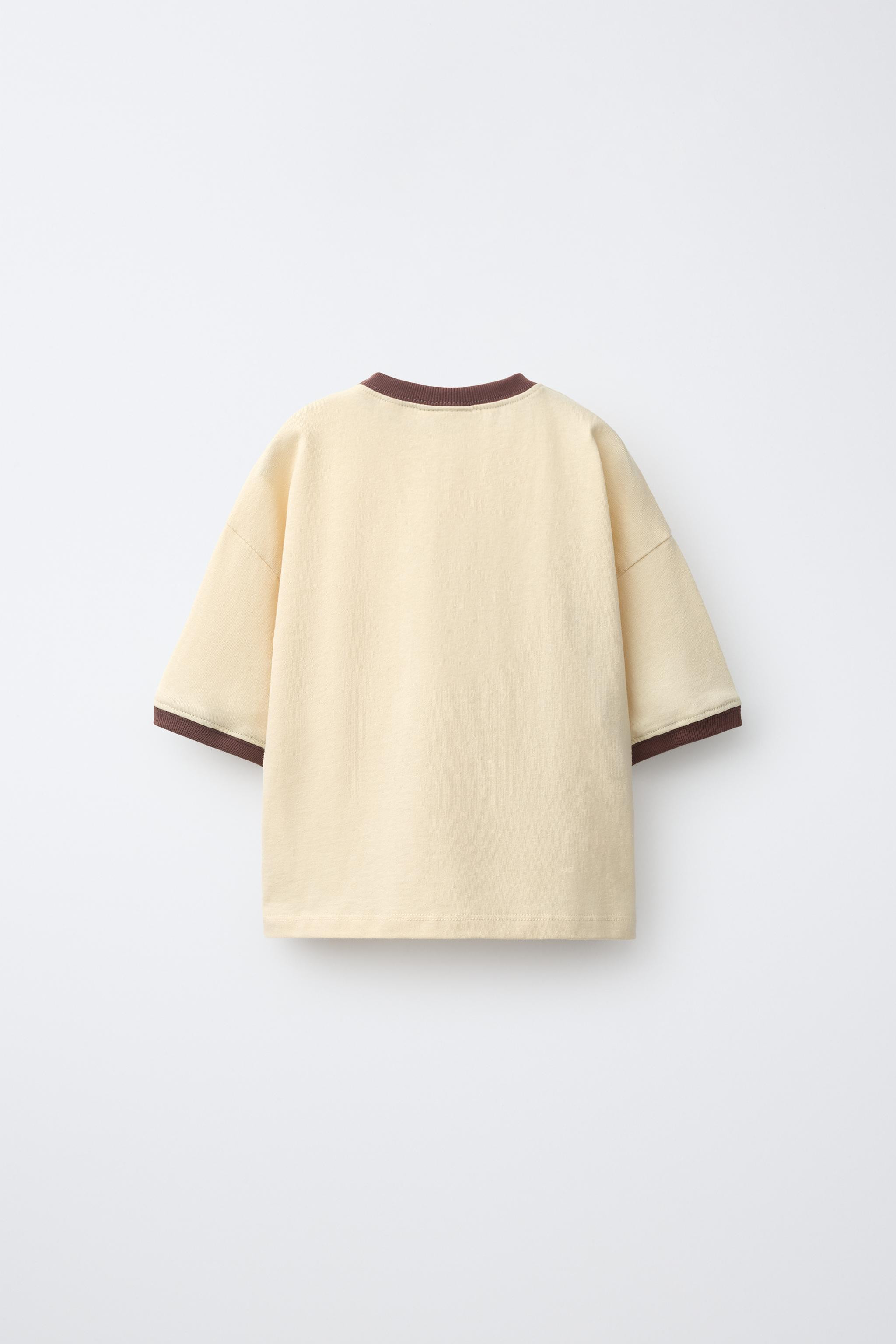 Short-sleeve crewneck T-shirt featuring contrasting piped detailing and an animal print on the fr... | Zara US