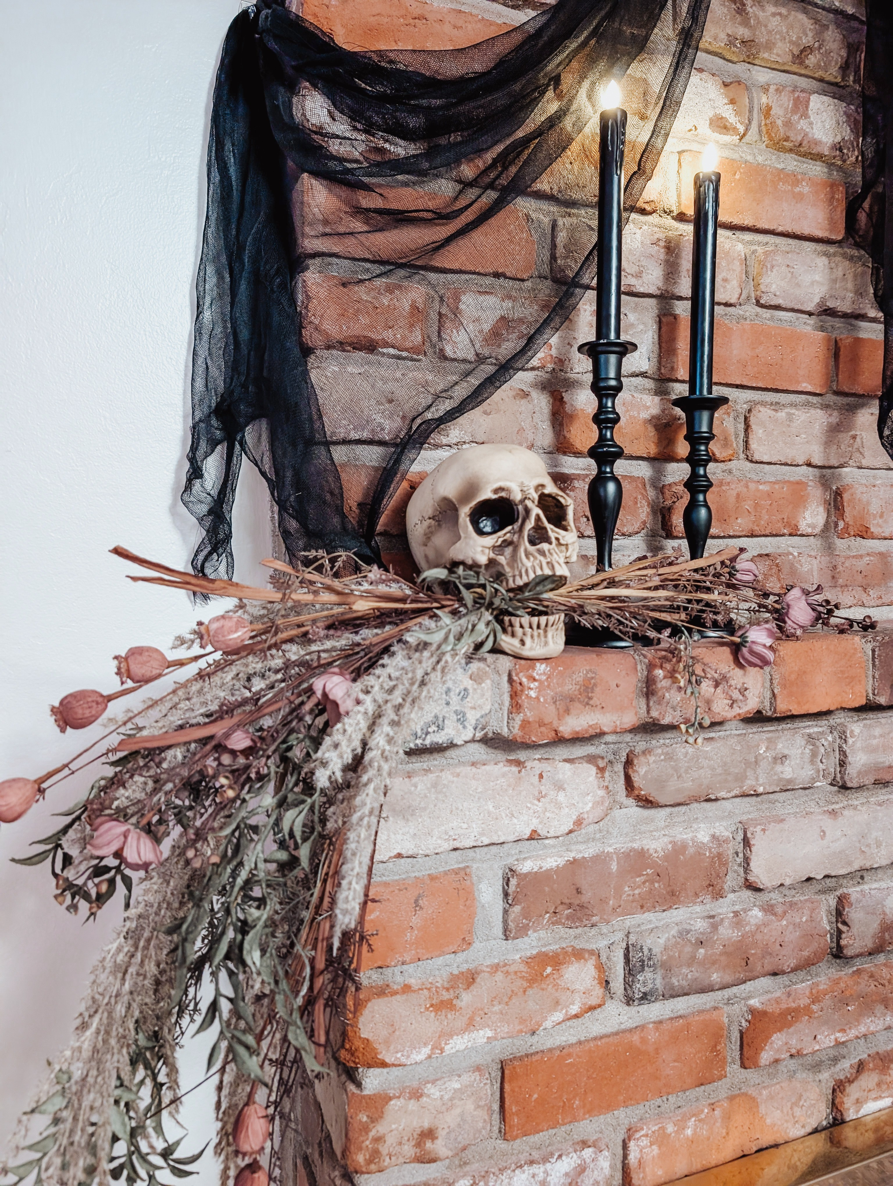 First Halloween DIY & decoration up on the brick mantel - skeleton skull with cascading stems! 

#LTKSeasonal #LTKHome #LTKParties