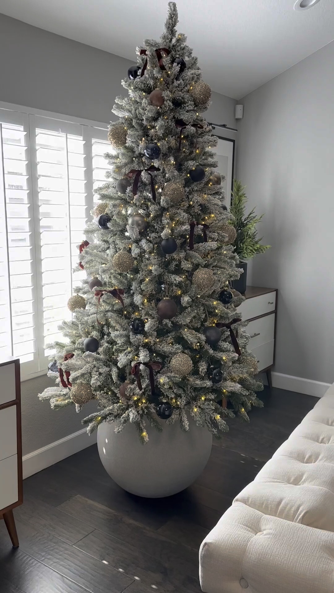 Christmas tree and holiday decorations …Flocked tree with round planter base 
Browns, blacks and rust ornaments I’m loving again this year…the crate and barrel ones are my absolute favorite!
I always have 7 trees out but I will change them up, switch up which trees get what ornaments, or rotate the trees out each year depending on my mood..I’ve never had a tree in this spot and love that the planter raises it higher than the couches to see it better, and it’s different and modern 
Modern organic, neutral Christmas decor 
#ltkseasonal

#LTKVideo #LTKHoliday #LTKHome