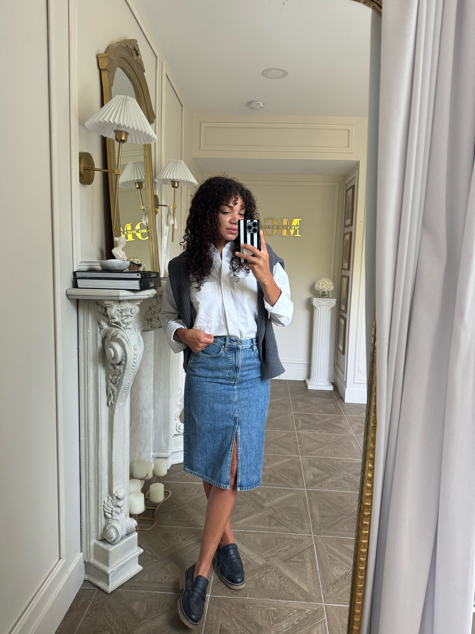 Preppy chic outfit idea: oxford, denim skirt, loafers, and a sweater. These pieces look great together, but can effortlessly be paired on their own too. This roomy and boxy oxford gives a casual take to this staple piece, easily making it a piece you can dress up or down all year round! #everlanepartner

#LTKSeasonal #LTKStyleTip #LTKFallSale