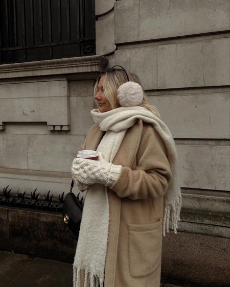 a cosy outfit for cold winter days with fluffy cream ear muffs, knitted mittens and a camel longline coat plus a shoulder coach tabby bag in black 

#LTKSeasonal #LTKeurope #LTKstyletip
