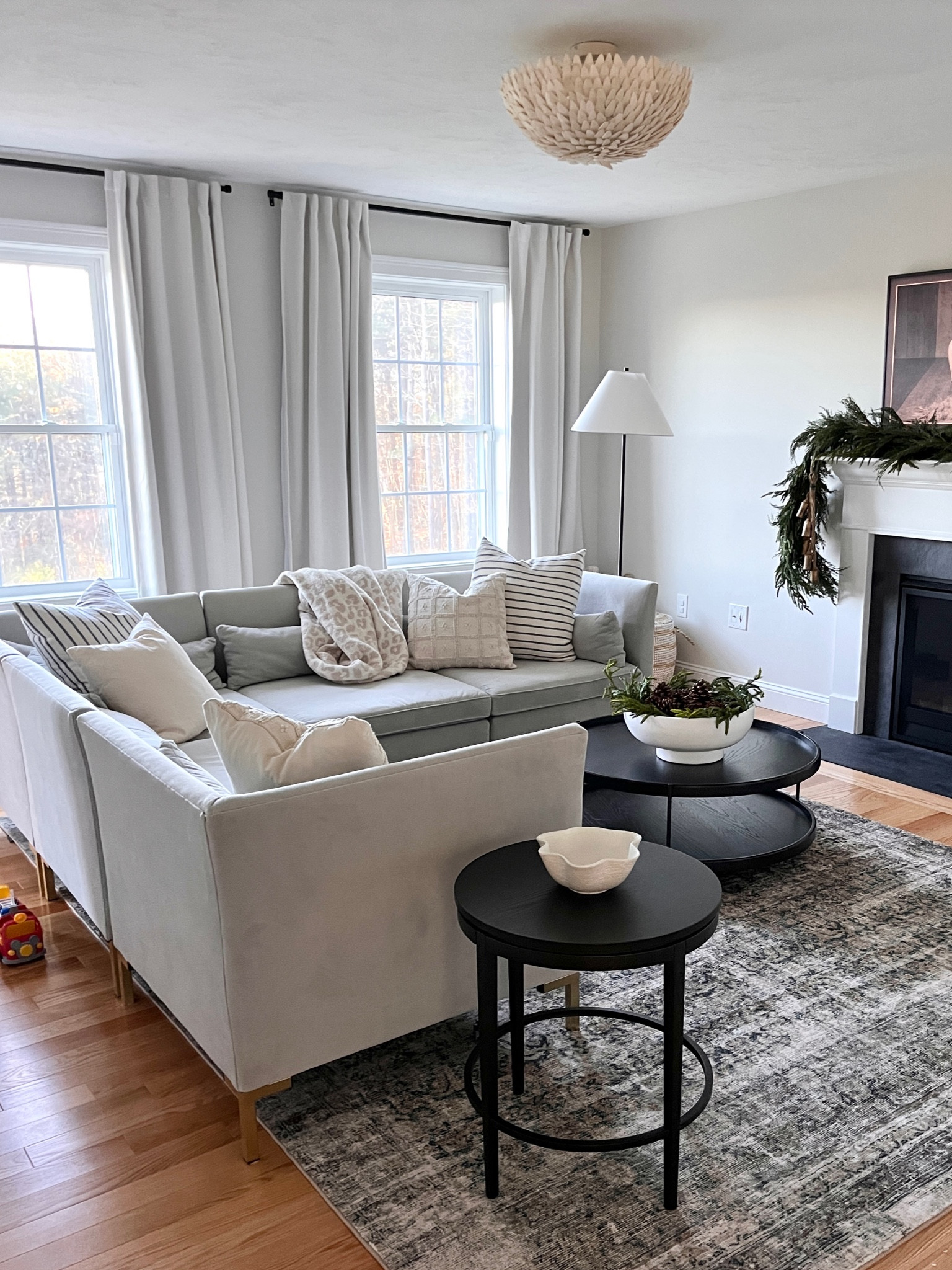 Living room design 
Neutral living room 
affordable drapes 
Target drapes 
Loloi Amber Lewis rug 
Round black coffee table
Affordable end table 
McGee and co threshold target 
McGee and co target 
McGee and co target accent table 
McGee and co pillows 
Joss and main floor lamp 
Black floor lamp 
Samsung frame tv 
Norfolk pine garland 

#LTKHolidaySale #LTKhome #LTKCyberWeek