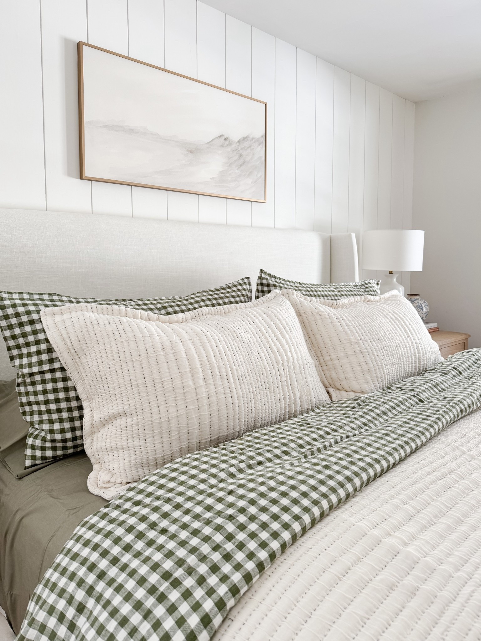 Neutral coastal bedroom with gingham bedding, layered throw blankets, textured knit coverlet, and soft patterned pillows. Light wood nightstands and white table lamps create a calm, layered spring bedroom look. 
gingham bedding, neutral bedroom decor, layered bedding, spring bedding, coastal bedroom, throw blanket, knit coverlet, patterned pillows, light wood nightstands, white table lamps, cozy bedroom, serene bedroom style, sherri calnan home

#LTKHome