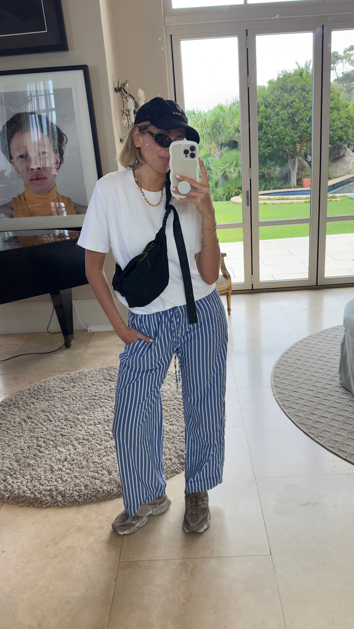 Travel outfit 
Striped trousers 
Pyjama trousers 
White tee 
Cross body bag 
New balance 

#LTKeurope #LTKtravel #LTKstyletip
