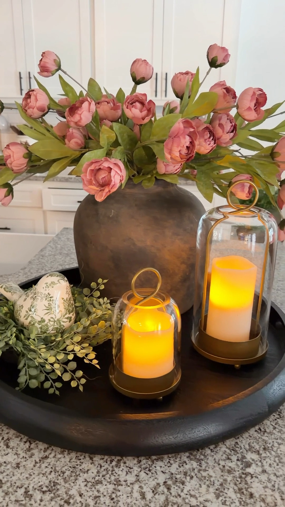 If you’ve been eyeing this black tray—this is your sign. It instantly grounds everything and elevates the whole look.

I styled one of my favorite vases, added hurricane lanterns that look high-end (but aren’t), and finished it with a candle ring and a sweet little bird for that layered touch.

Such an easy look that flows right from spring into summer! 