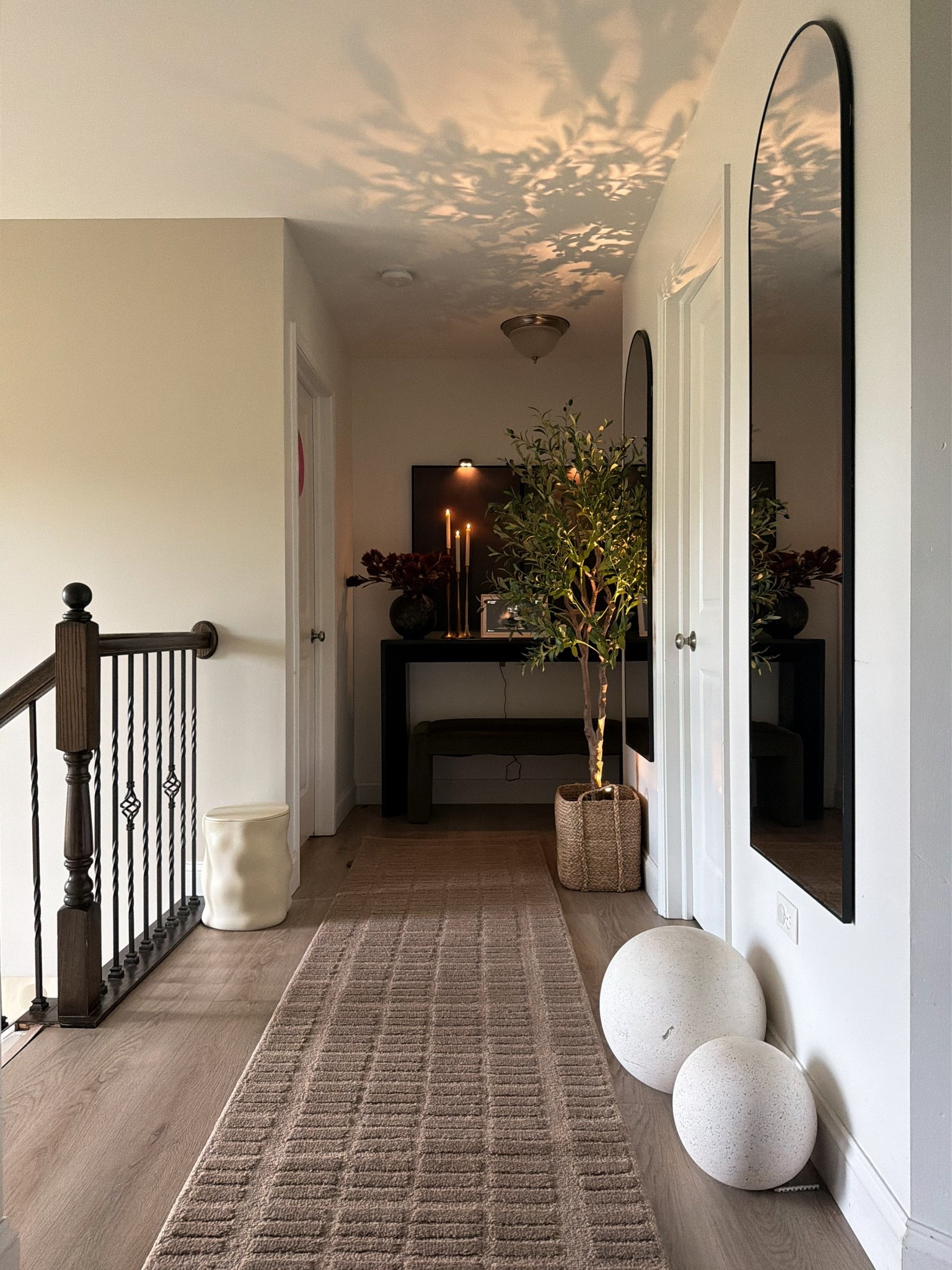 From basic to warm & collected 🤎 Proof that even the most builder-grade spaces can feel intentional with a few thoughtful details. Layering in texture, warm lighting, greenery, and pieces I love to make this hallway finally feel like home. ✨

#LTKHome