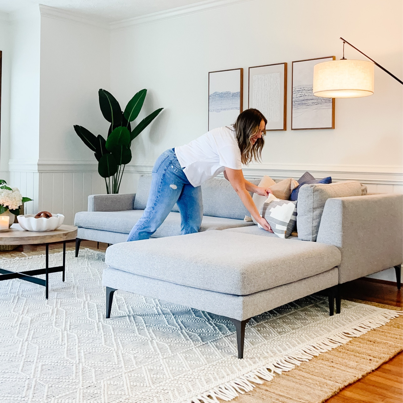 Shop the look! Beautiful sectional sofa with ottoman, layered rugs. Art work. Indoor plants. Floor lamp. Coffee table and home decor. 

#LTKfamily #LTKhome #LTKsalealert
