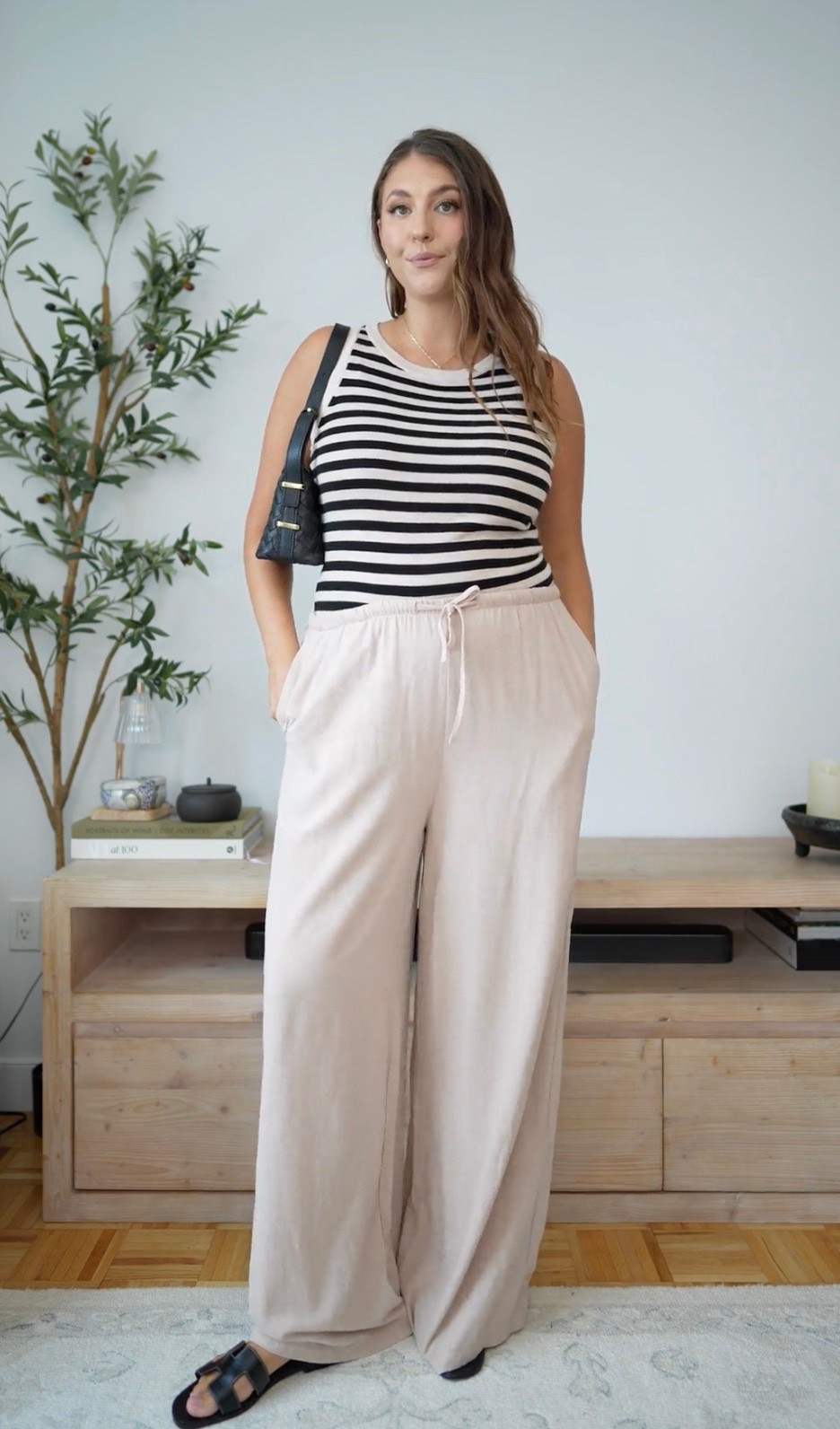 Obsessed with this kind of summer outfit. The striped tank and flowy linen pants feel effortless but still pulled together, and the black accessories keep it chic. Perfect for errands, lunch, or vacation days when you want to be comfortable without looking sloppy.

striped tank linen pants summer outfit casual chic neutral outfit effortless style summer fashion wide leg pants black sandals everyday outfit

#LTKootd #LTKMidsize #LTKTravel
